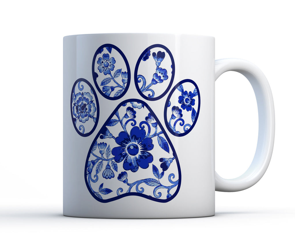 Ceramic mug with pretty blue and white flower dog paw print artwork.
