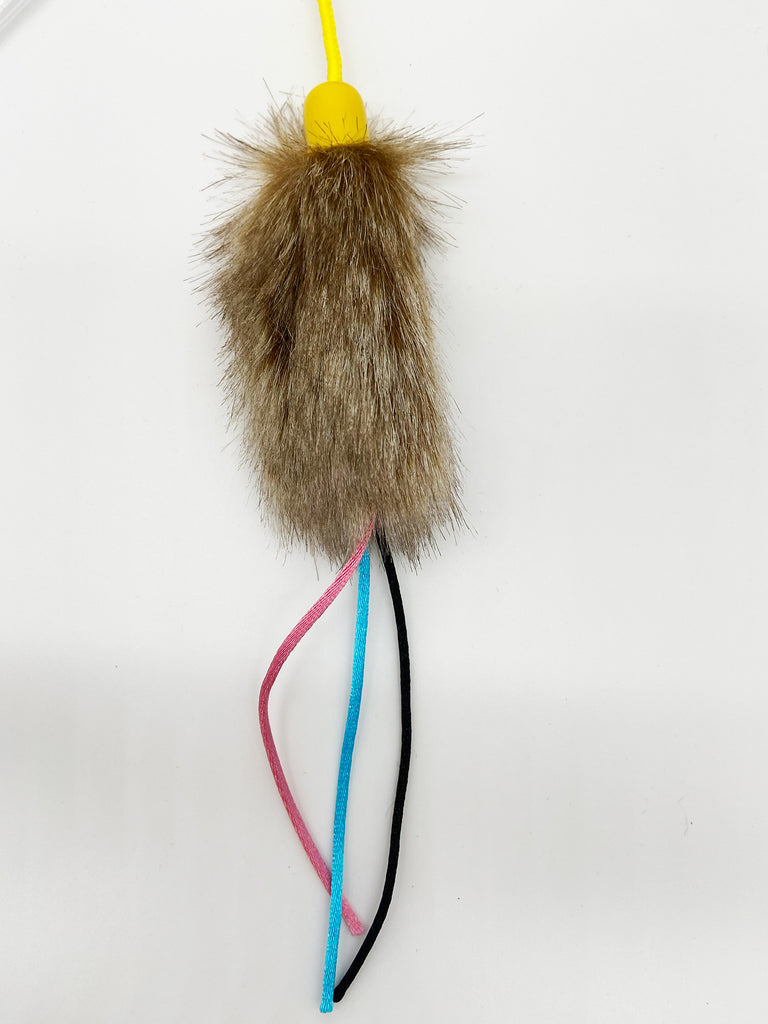 This is a close up of the Go Fur It lure. It is constructed of faux fur and reinforced woven satin cords. The realistic faux fur will give the cat the sensation of pouncing on a live animal while the cords flap through air for extra attention grabbing action.  The lure is meant to engage the cat's hunting instincts. 
