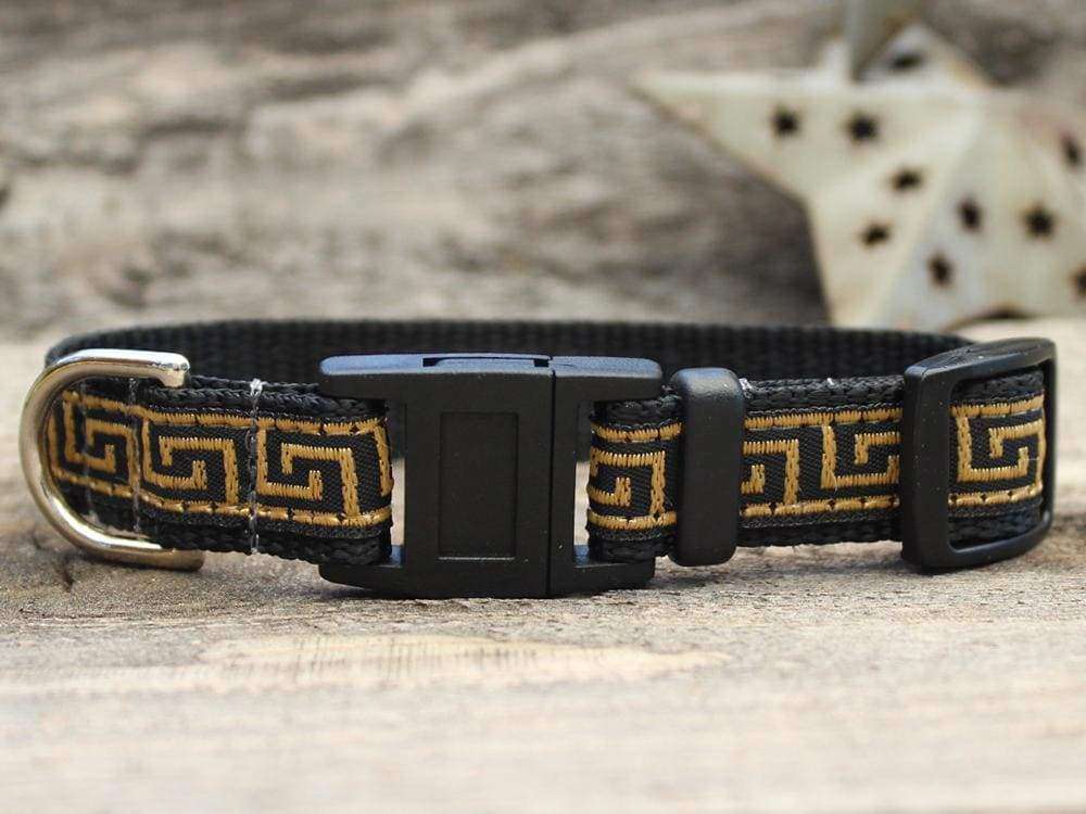 This is the Caesar Break Away Cat Collar by Diva Dog and Surf Cat. The collar has a Greek geometric design, with lines creating a maze look across the collar. The lines are of golden brown hue. The collar was manufactured in the USA. It has breakaway buckles that pop open under a minimal eight pounds of pull, which helps prevent choking. The collar is made of of soft and comfortable nylon overlaid with durable polyester ribbon. The material is quintuple stitched at stress points for added strength.