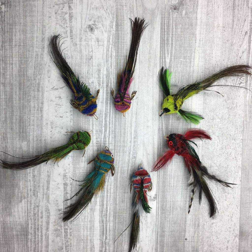 These are Pretty Fly Fish Teaser Wand Cat Toy Replacement Lures by Catboutique. They are made from deer hair and have a peacock eye feather for a tail. They come in an assortment of color variations and styles.  Each lure is colored with a dye that isn't harmful to cats. This lure is meant to engage at the cat's hunting instincts like prowling, pawing, and pouncing.