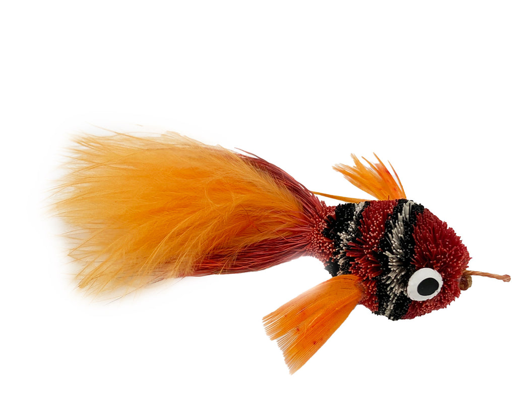 This is a Pretty Fly Clownfish Teaser Wand Cat Toy Replacement Lure by Catboutique. It is burnt orange-red. The fish has black and white stripes. There is a feather tail. The lure is made of deer hair and is dyed a dye that isn't harmful to cats. This lure is meant to engage at the cat's hunting instincts like prowling, pawing, and pouncing.
