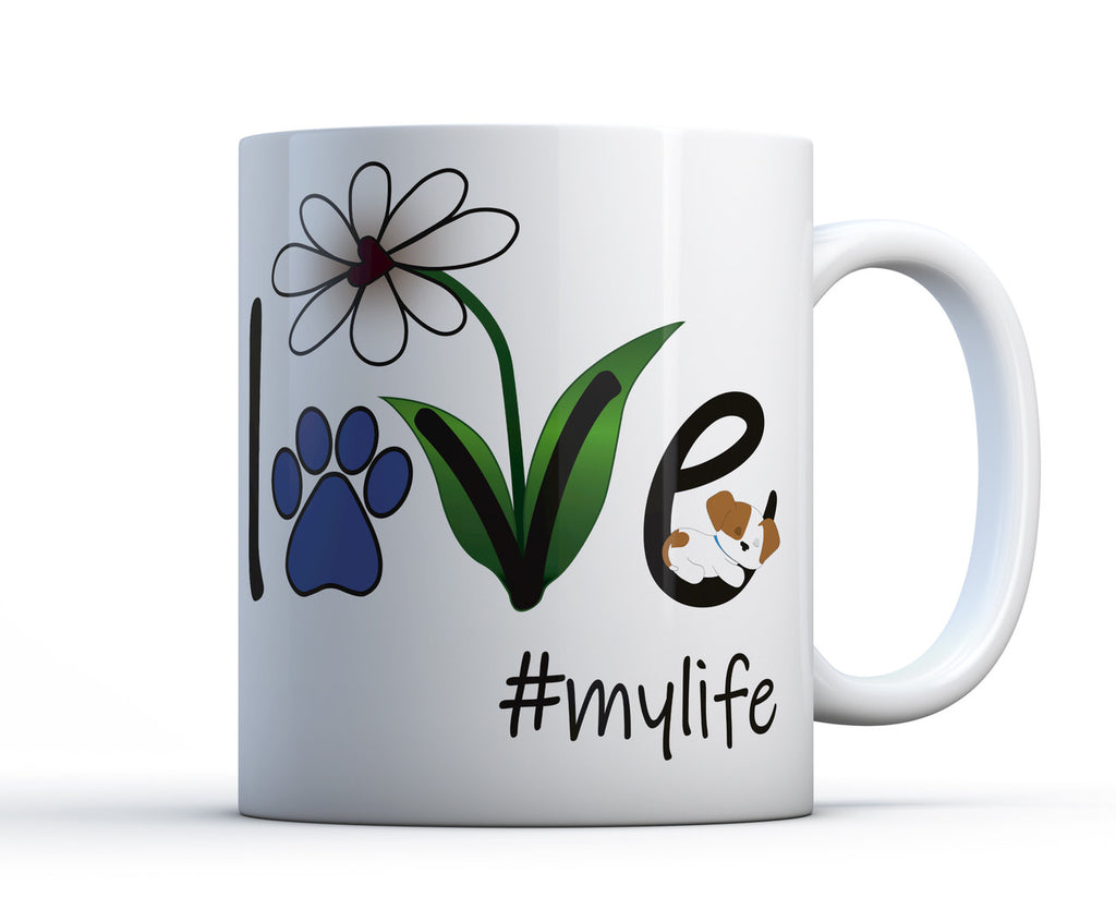 A white ceramic coffee mug with Love #mylife graphic, a flower and a sleeping dog or puppy. 