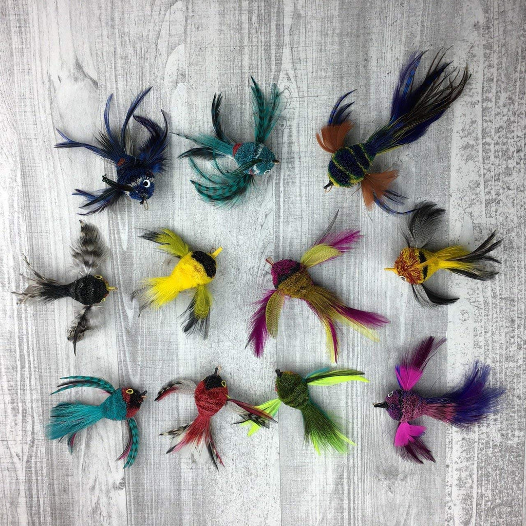 These are Pretty Fly Bird Teaser Wand Cat Toy Replacement Lures by Catboutique. The birds are made from real deer hair and dyed. The dye uses isn't harmful to pets. The birds come in a variety of colors from turquoise and white to hot pink and purple. Each bird has real feathers for a tail and wings. These lures are  meant to engage at the cat's hunting instincts like prowling, pawing, and pouncing. They work best with a teaser wand cat toy. 