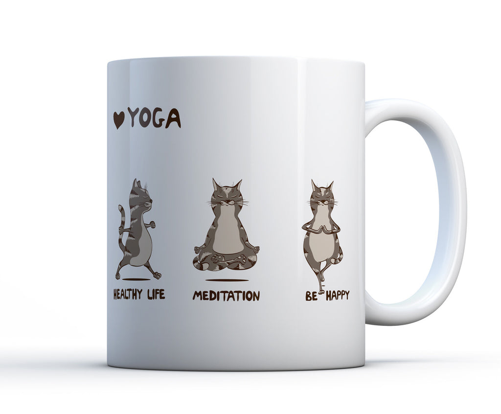 White ceramic coffee cup with 3 cats performing yoga poses with the words yoga, healthy life, meditate and be happy.