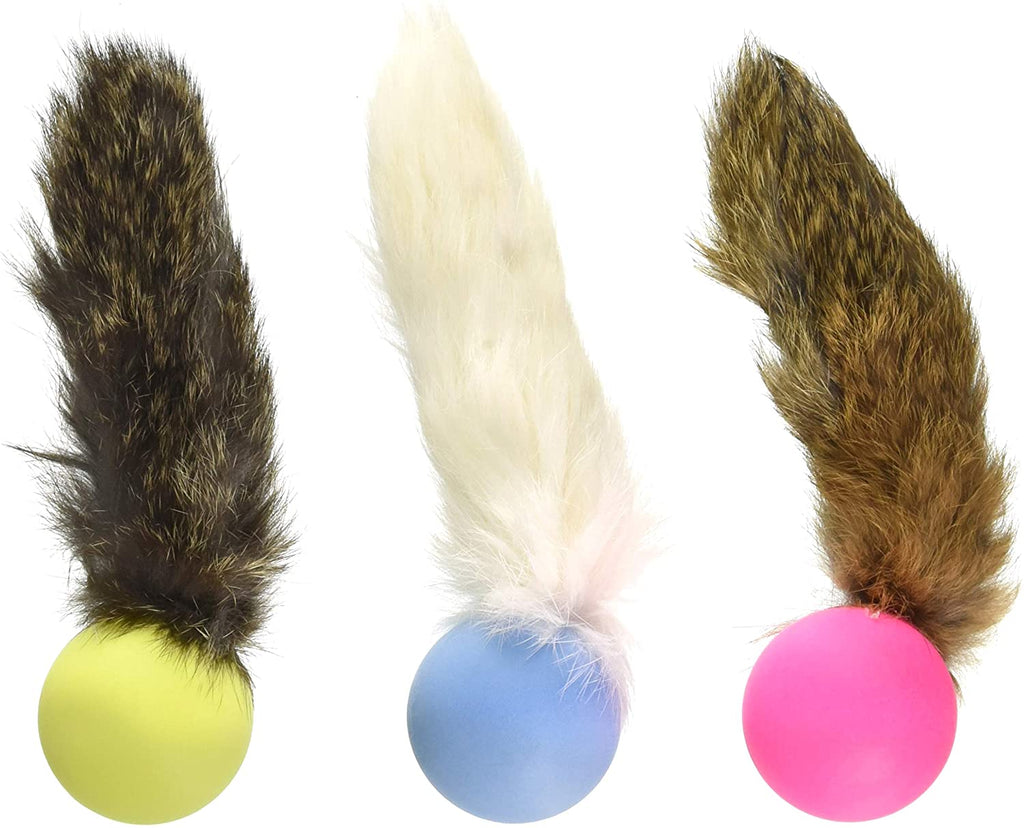This is an assortment of Fur Pong Cat Toys by  Go Cat. Each toy is comprised of a real handmade fur tail with a ping pong ball on the end. There are yellow,  light blue, and pink ping pong balls. One tail has black, and tan fur. Another tail has all white fur. The last toy has a tan, black, and orangish tinted tan fur. Each ping pong ball is filled with catnip and rice to attach the cat more. The toy is meant to engage the cat's instincts such as pawing, prowling, and pouncing. 